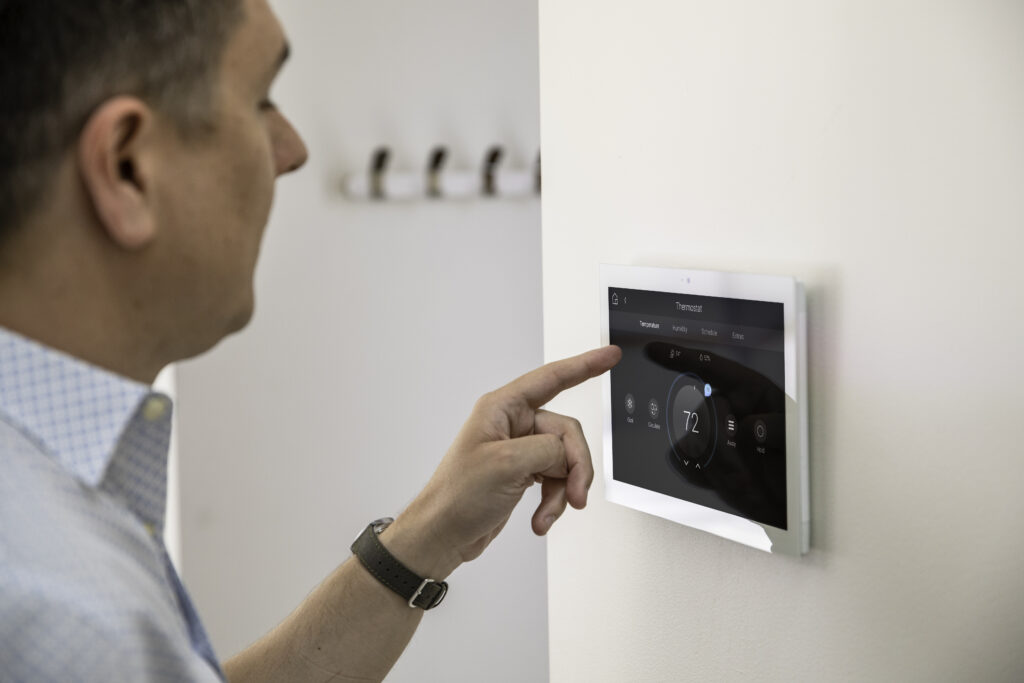 Control4 installer sets up a wall mounted Control 4 tablet in White