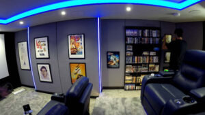 Fabric wall with framed movie posters in the home cinema room 